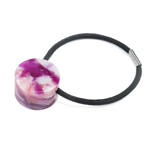 Detail view of purple marble resin bead on a high-elasticity black hair tie for women