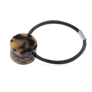 Minimalist elastic hair tie featuring a geometric leopard print acetate cylinder piece