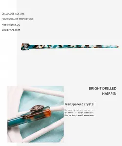 Detail view of cellulose acetate hair pin with green marble pattern and clear rhinestone