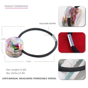 Elastic hair tie with geometric marble pattern cellulose acetate cylinder and metal clasp