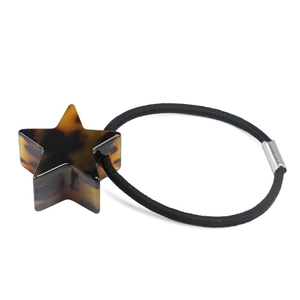 Dettaglio di stella in acetato tartarugato su elastico per capelli nero