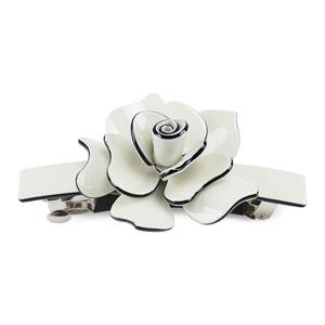 Detail of elegant cream rose hair clip with black edges and secure metal spring clasp