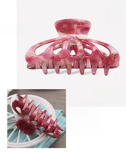 Detail view of tie-dye acrylic hair claw clip with 8.9x4.5cm dimensions and hollow design