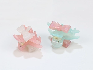 Set of two pastel acrylic hair claws with pearl luster and delicate bow accents
