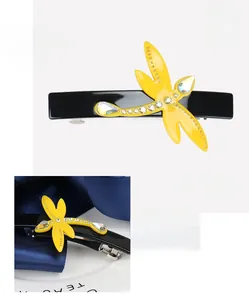 Detail of dragonfly hair clip made from yellow France acetate and sparkling rhinestones