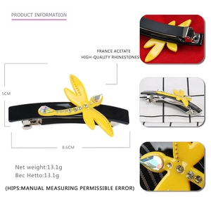 Detailed view of yellow dragonfly hair clip with crystals and 8.6cm size dimensions