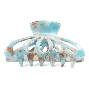 Detail view of large marble texture acetate hair claw clip with blue and white tie-dye