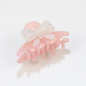 Elegant acrylic hair claw clip featuring a translucent pink body and white pearl bow