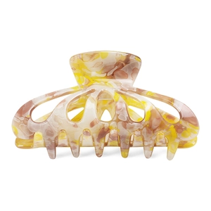 Detail view of tie-dye acetate hair claw with yellow and brown marble patterns