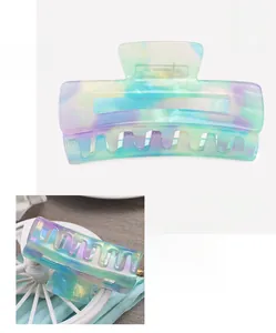 Detail view of cellulose acetate hair claw clip with colorful marble texture and dimensions