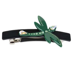 Macro detail of dragonfly spring hair clip featuring green rhinestones on black resin base