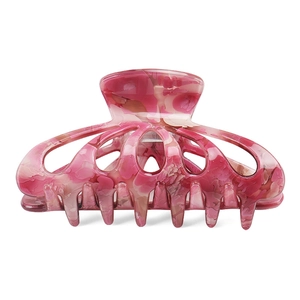 Detailed macro view of large pink marble tie-dye acetate hair claw with hollow design