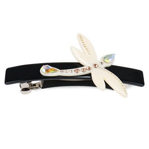 Detailed macro view of dragonfly hair clip with brown rhinestones and crystal wings