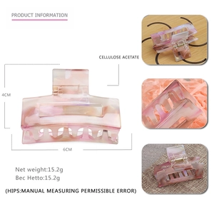 Detail showing marble texture acetate hair claw clip with 6cm length and 4cm height