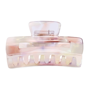 Detail of large acetate hair claw clip featuring purple marble texture and gold metal spring