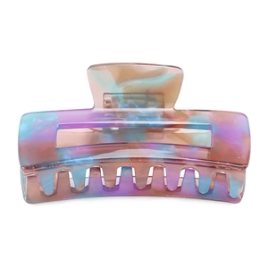 Detail of large marble hair claw clip with lilac and amber resin texture and 14-tooth comb
