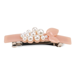 Detail view of pink acetate hair clip with white pearls and silver metal spring clip