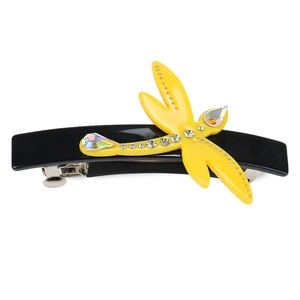 Macro detail of a dragonfly hair clip with yellow wings and shimmering rhinestones