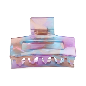 Detailed view of colorful marble acetate hair claw clip with geometric cutout design
