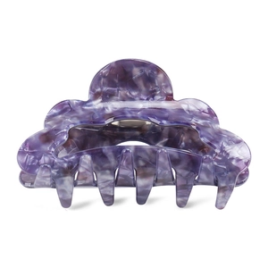 Detailed view of the purple marble acetate hair claw clip with scalloped wave edge
