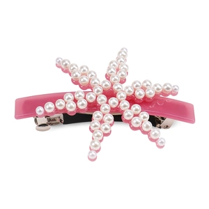 Detail shot of pink resin hair clip with elegant starfish pearl pattern and spring mechanism