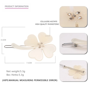 Elegant white acetate four-leaf clover hair claw clip with sparkling rhinestones