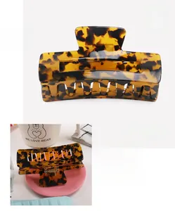 Detail view of tortoiseshell acetate hair claw clip showing 10x4.5cm size and weight