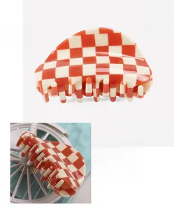Detailed size and weight specs of the orange and white checkered acetate hair claw clip