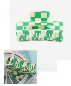 Macro detail of checkered green and white acetate hair claw clip with size specifications