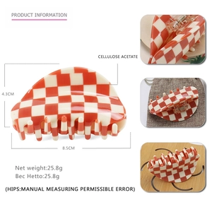 Orange checkerboard cellulose acetate claw clip for hair measuring 8.5cm x 4.3cm