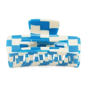 Close-up of blue checkerboard hair claw clip made of acetate with secure inner teeth