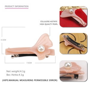 Detail view of pink ginkgo leaf spring hair clip with pearl and acetate texture