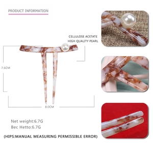 Detail view of acetate hair pin showing measurements 7.6cm by 8cm and pearl accent