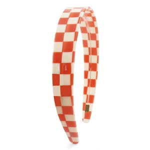 Detail of vibrant orange and cream checkerboard pattern on high-gloss acetate headband