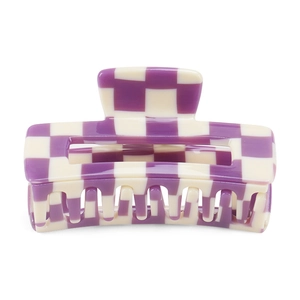 Close-up of large rectangular hair claw clip with purple and cream checkered pattern