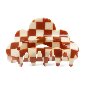Close-up of brown and white checkered hair claw clip with scalloped edges and metal spring
