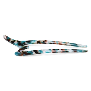 Detailed close-up of U-shaped hair pin featuring blue and white tortoiseshell acetate texture