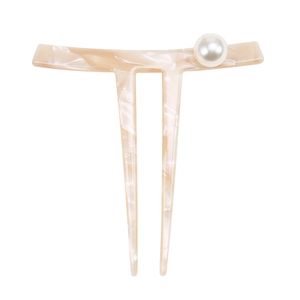 Detail of a U-shaped marble acetate hair fork with elegant white pearl decoration