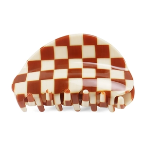 Close-up of red and cream checkerboard pattern hair claw clip with glossy finish