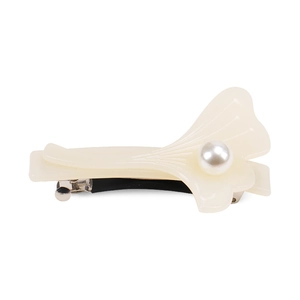 Detail of ginkgo leaf hair clip with cream resin petals and center pearl inlay