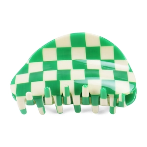 Green and white checkerboard semicircular acetate hair claw clip on white background