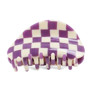 Detailed close-up of a purple and cream checkered acetate claw clip with a glossy finish