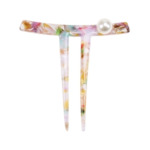 Detail view of acetate U-shaped hair pin with colorful marble pattern and pearl accent