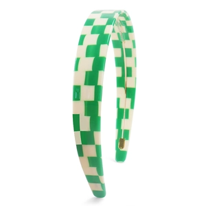 Detail of green and white checkerboard headband with glossy finish and metal support