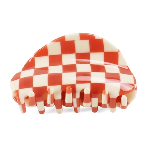 Macro view of semi-circular acetate hair claw clip with red and cream checkerboard pattern