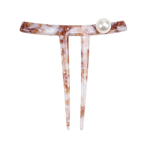 Detail of tortoise shell acetate hair pin with two prongs and a white faux pearl accent