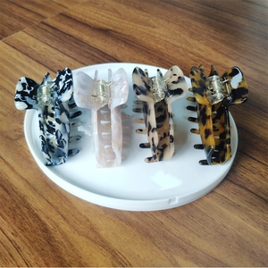 Set of four minimalist acetate hair claws with elegant marble and tortoiseshell patterns
