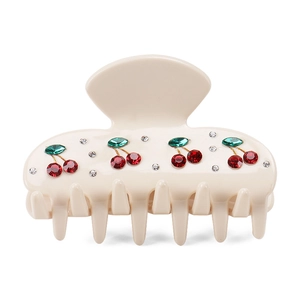 Close-up of cream hair claw clip with exquisite red cherry rhinestones detail
