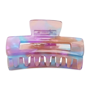 Detail of colorful acetate hair claw with pastel gradient marble pattern and hollow design