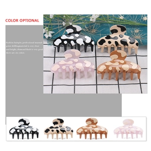 Cow print acetate hair claw clips in various colors for elegant ponytail styling